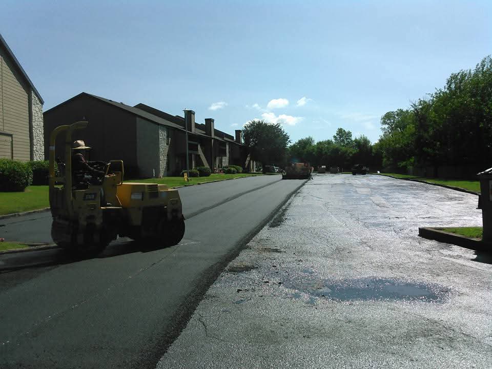 Roller on fresh asphalt at apartment complex
